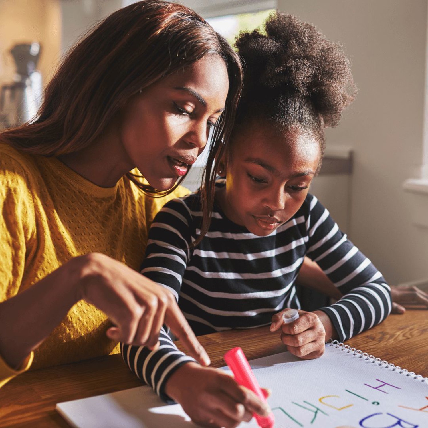 Parent and child writing together